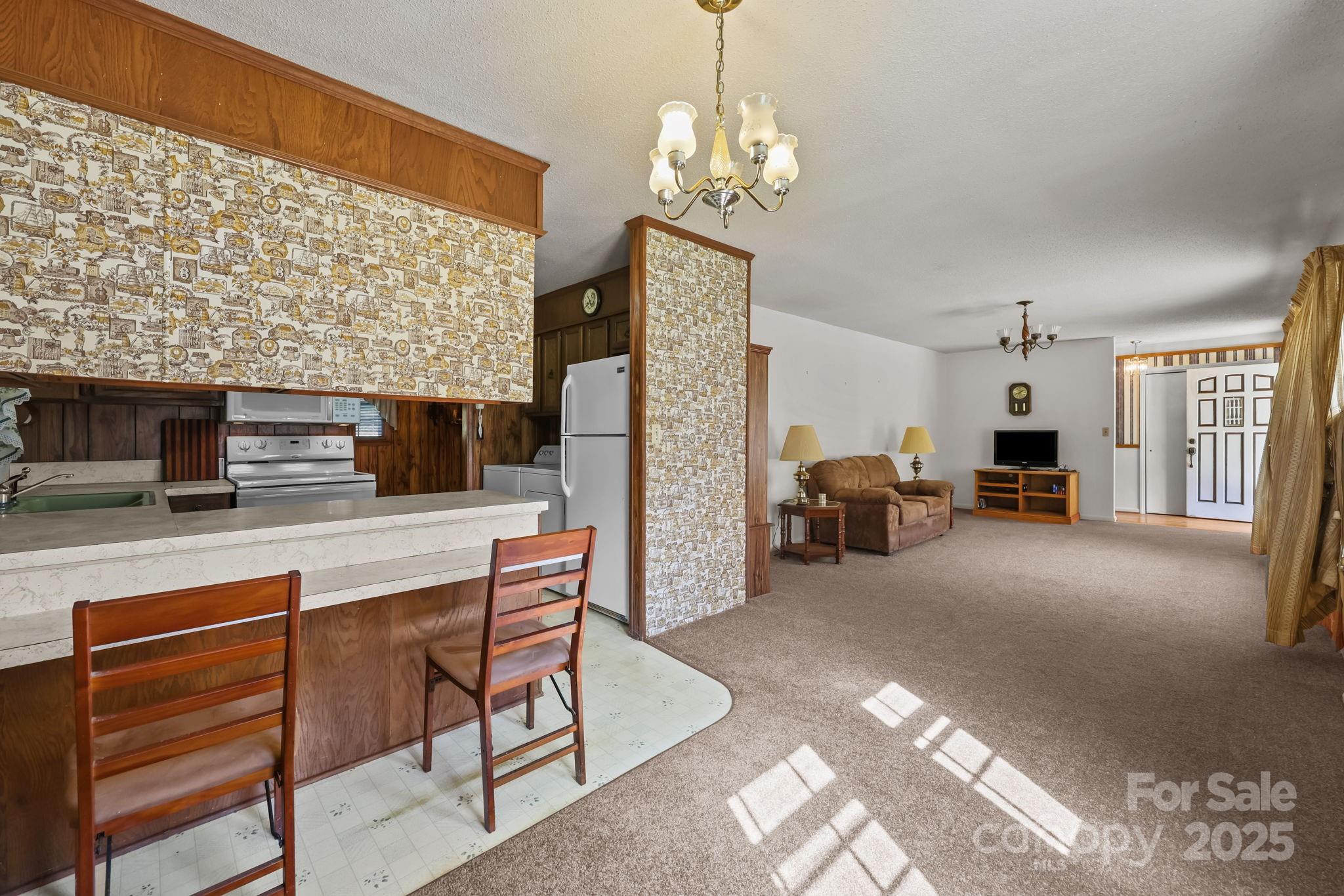 2440 Emanuel Church Road Rockwell, NC 28138 - Photo 12 of 41 a living room with furniture and a chandelier
