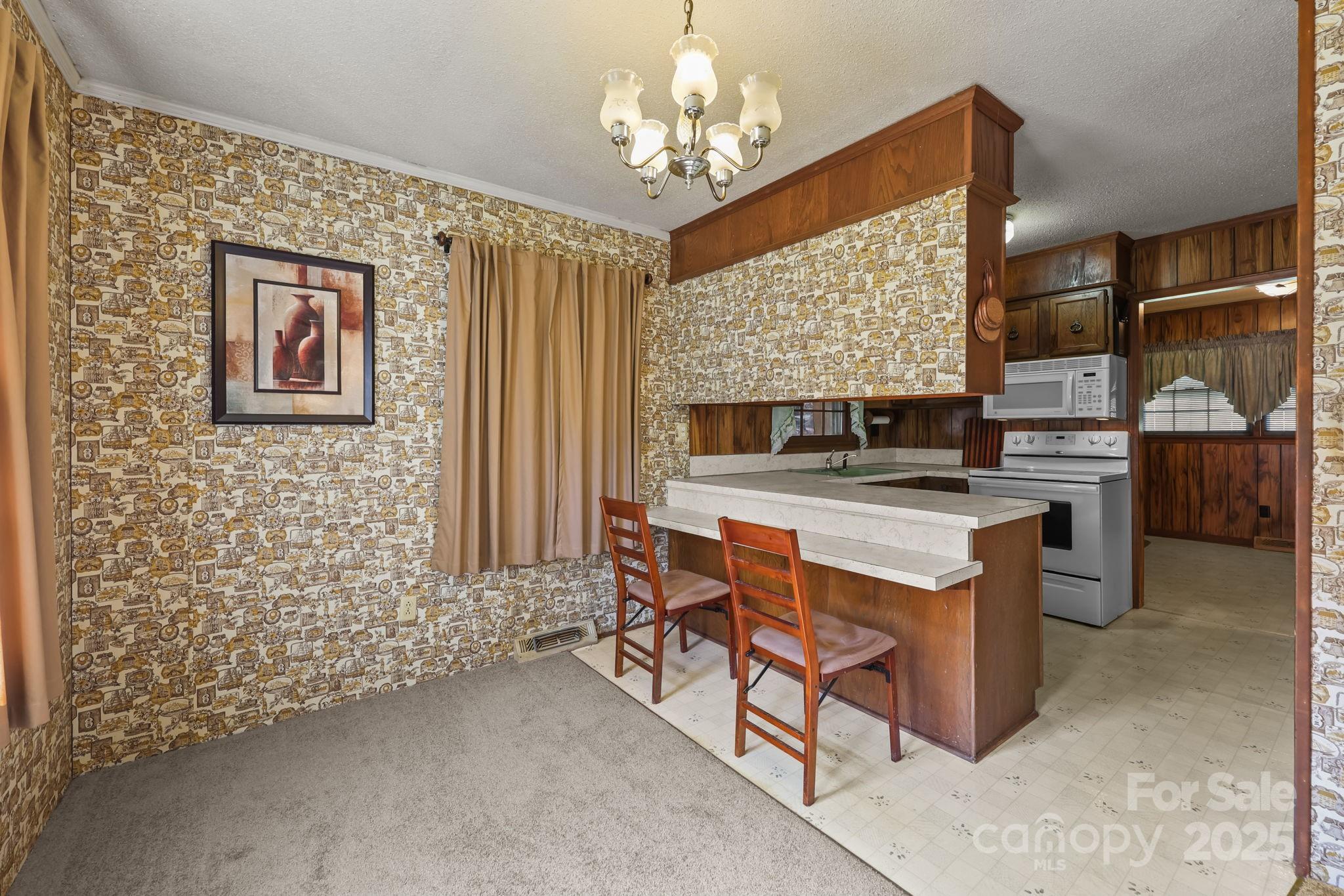 2440 Emanuel Church Road Rockwell, NC 28138 - Photo 13 of 41 a open kitchen with stainless steel appliances granite countertop a stove top oven a sink dishwasher and a dining table with the kitchen view