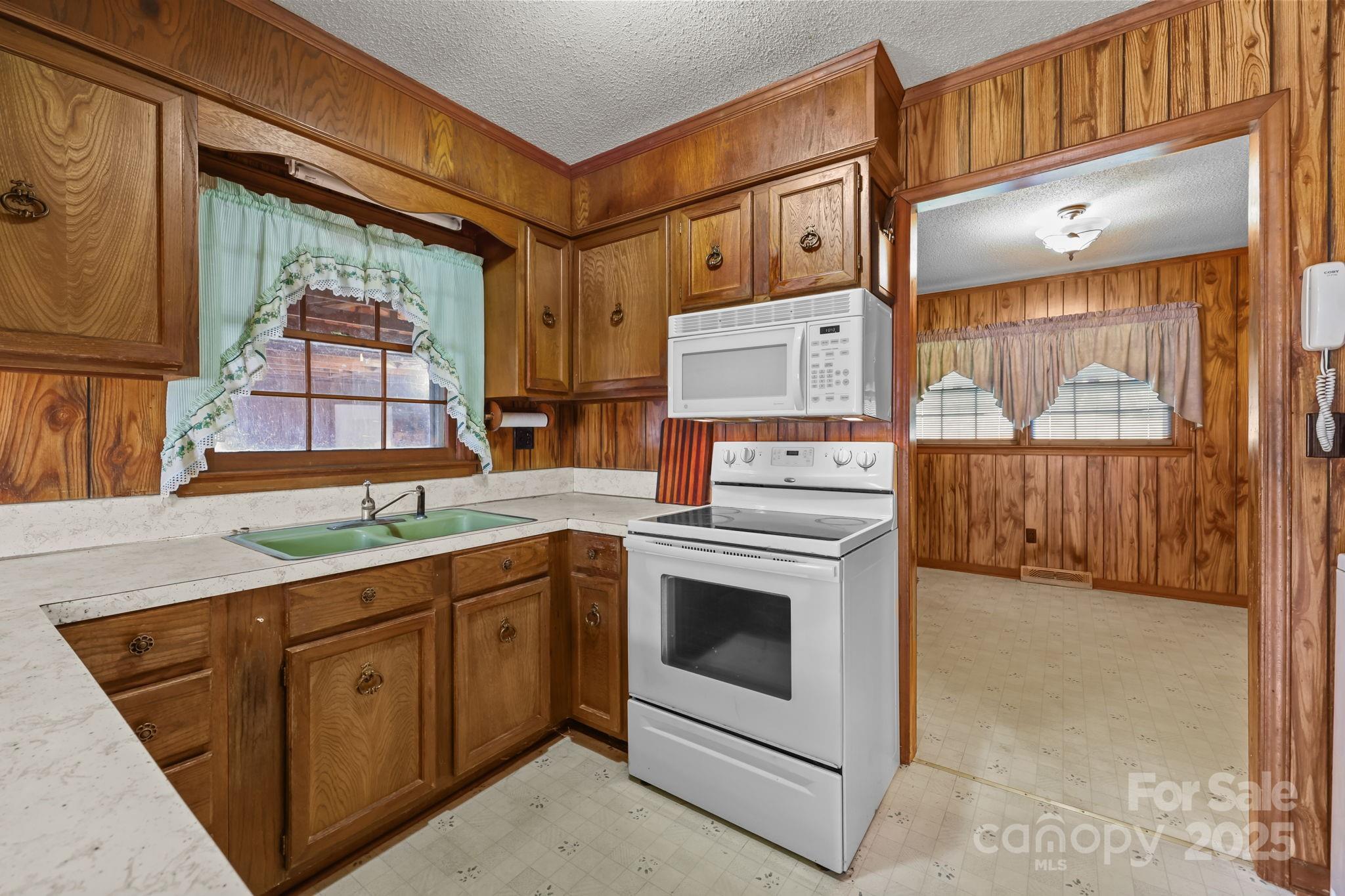 2440 Emanuel Church Road Rockwell, NC 28138 - Photo 14 of 41 a kitchen that has a sink and a stove in it