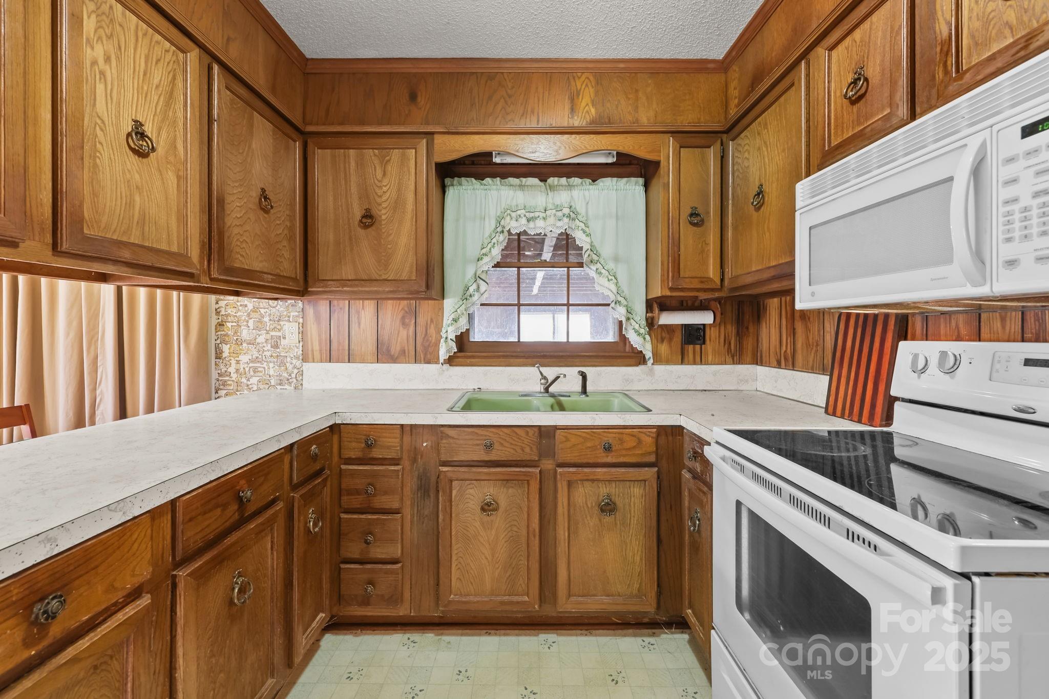 2440 Emanuel Church Road Rockwell, NC 28138 - Photo 16 of 41 a kitchen with a sink stove and cabinets