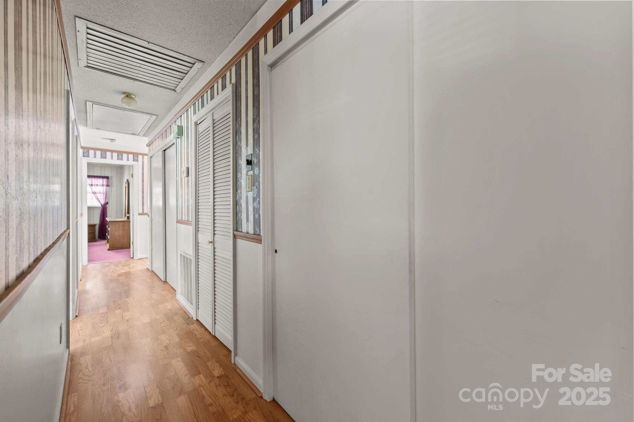2440 Emanuel Church Road Rockwell, NC 28138 - Photo 20 of 41 a view of a hallway with wooden floor