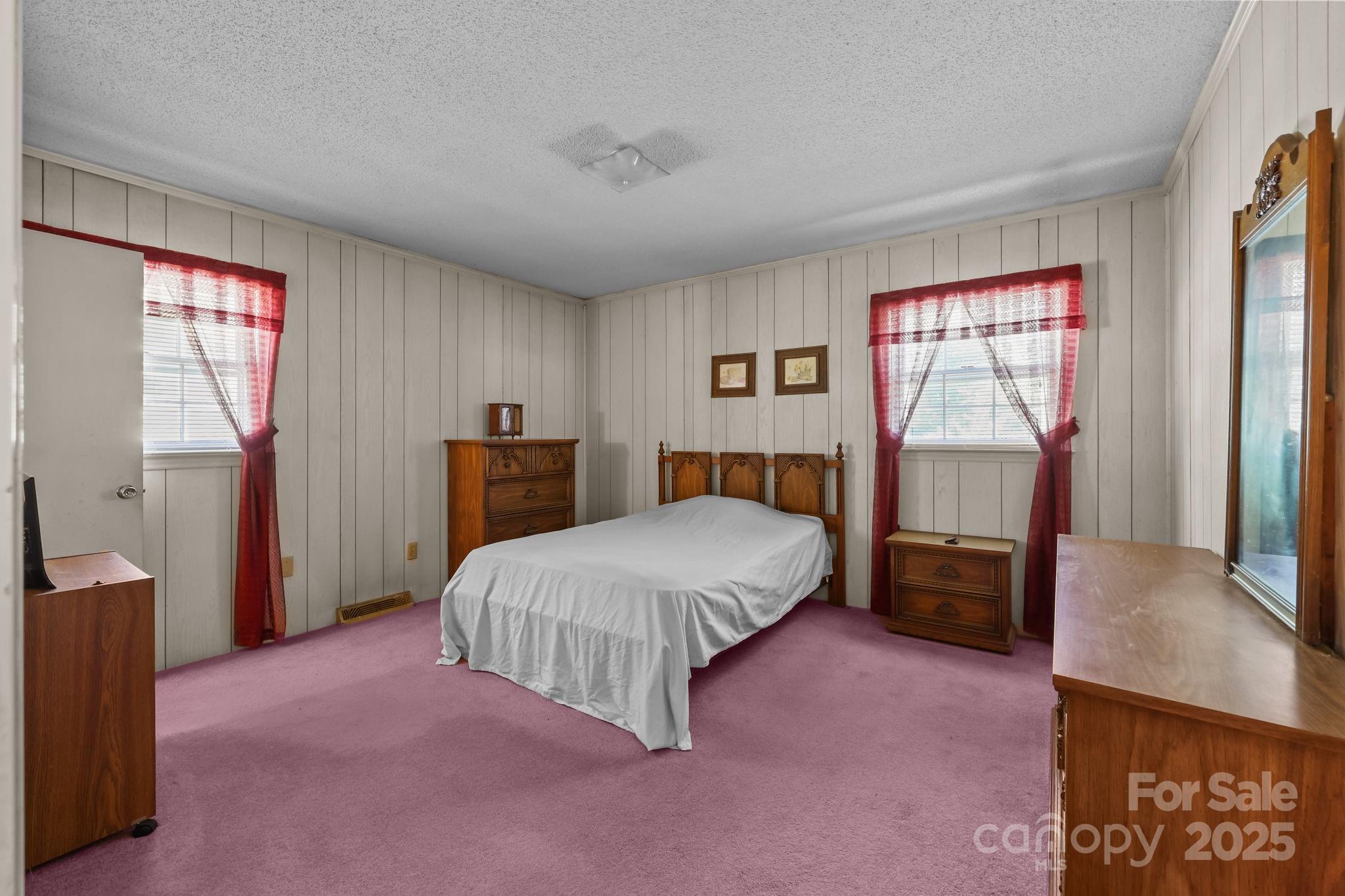2440 Emanuel Church Road Rockwell, NC 28138 - Photo 27 of 41 a bedroom with a bed and dresser with mirror