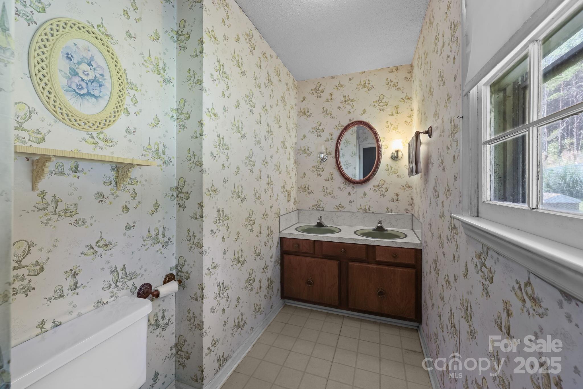 2440 Emanuel Church Road Rockwell, NC 28138 - Photo 29 of 41 a bathroom with a toilet sink and mirror