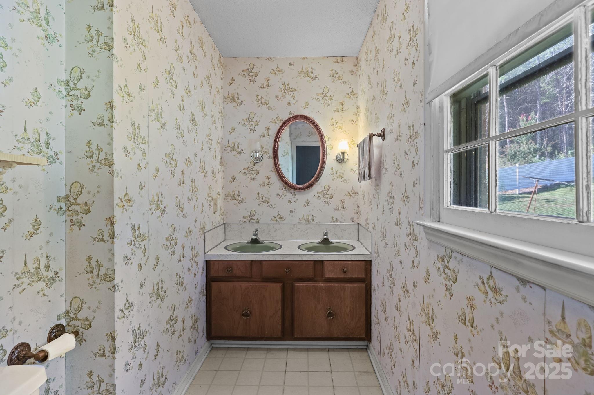 2440 Emanuel Church Road Rockwell, NC 28138 - Photo 30 of 41 a bathroom with a sink a toilet and a mirror