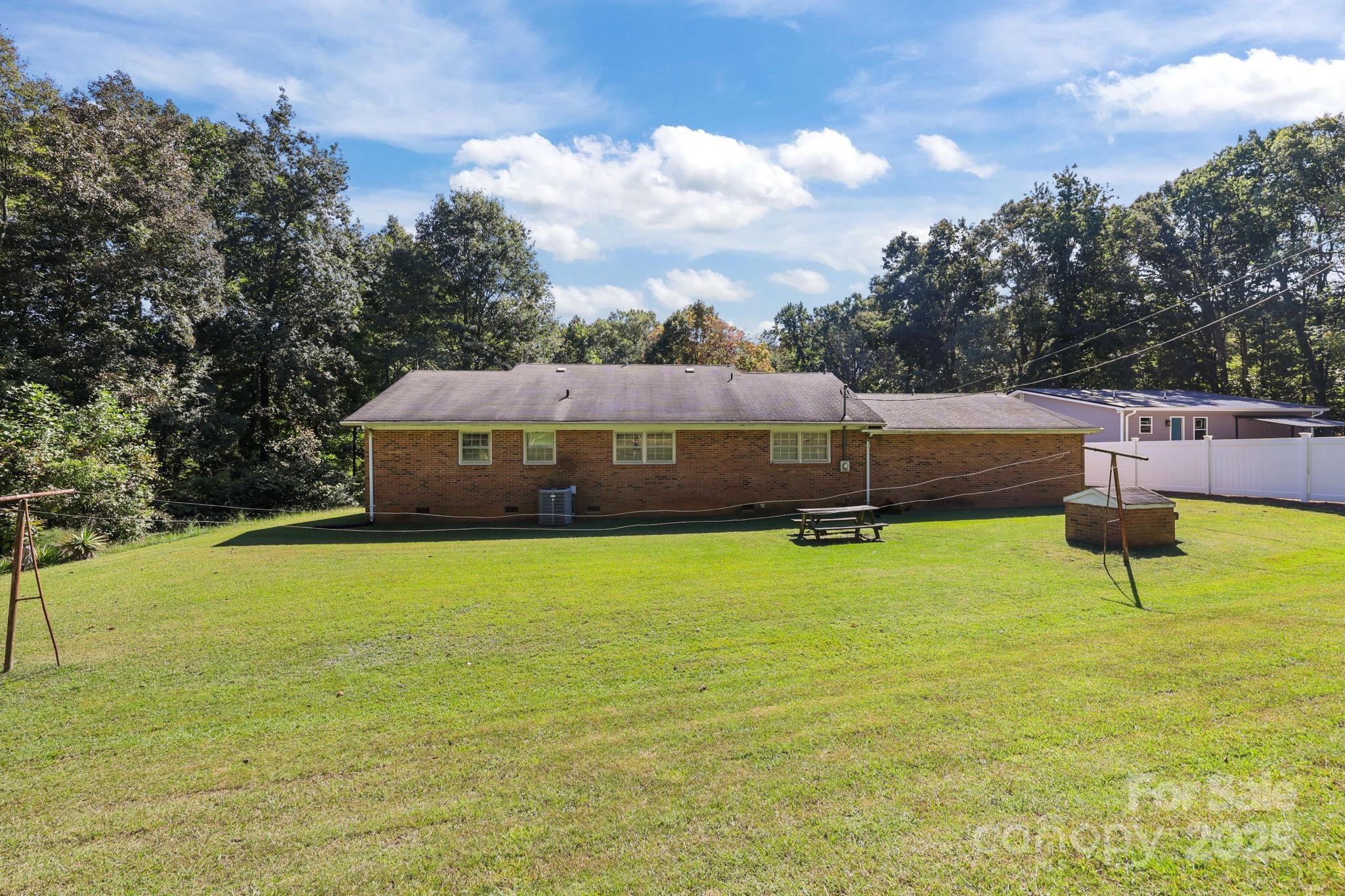 2440 Emanuel Church Road Rockwell, NC 28138 - Photo 35 of 41 a view of a swimming pool with an outdoor seating and yard