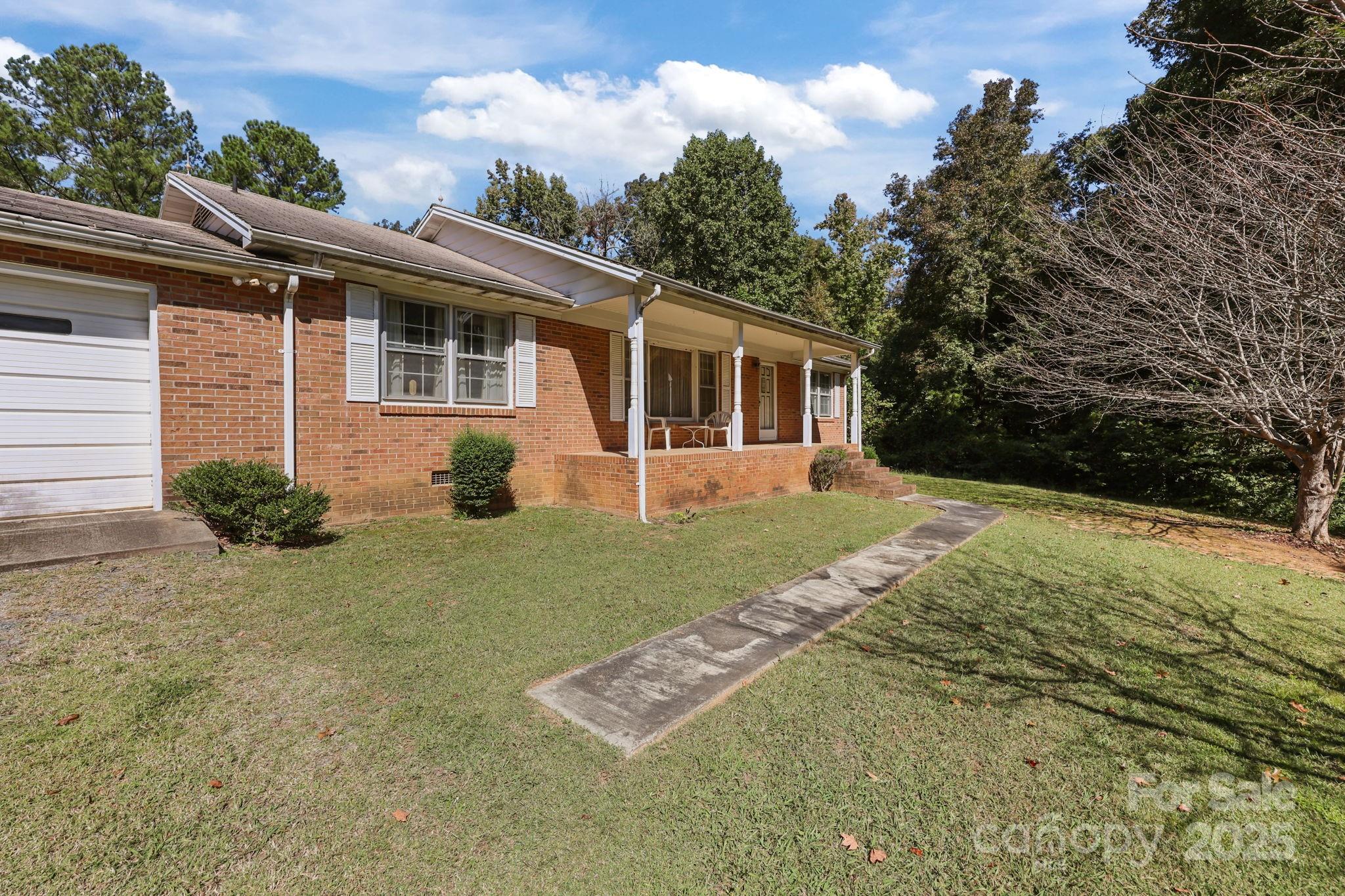 2440 Emanuel Church Road Rockwell, NC 28138 - Photo 4 of 41 a view of a house with backyard and garden