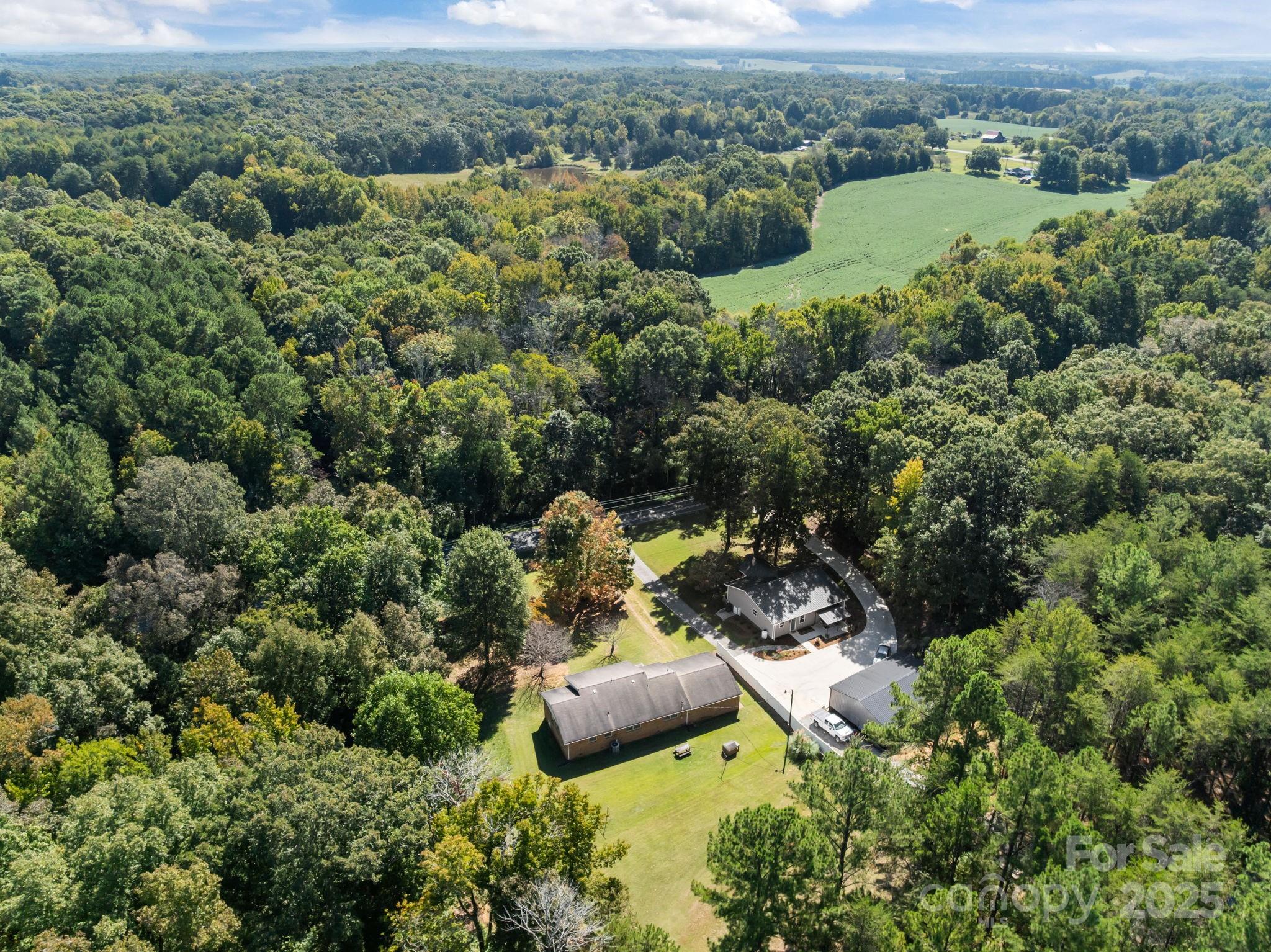 2440 Emanuel Church Road Rockwell, NC 28138 - Photo 41 of 41 an aerial view of a forest with houses