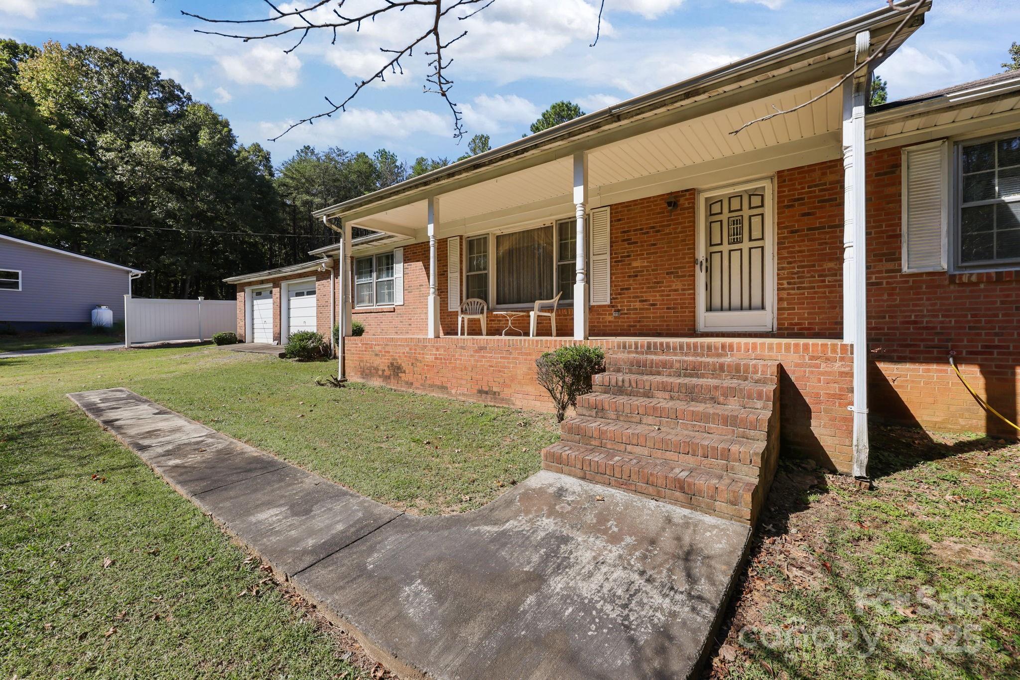 2440 Emanuel Church Road Rockwell, NC 28138 - Photo 5 of 41 a front view of a house with garden