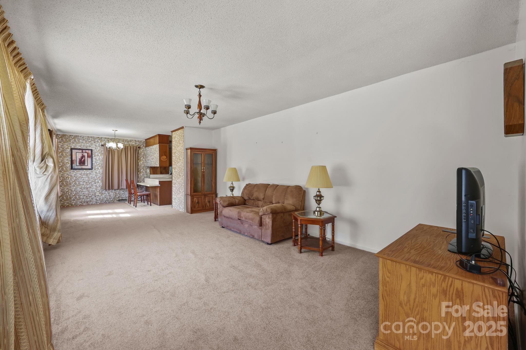 2440 Emanuel Church Road Rockwell, NC 28138 - Photo 10 of 41 a living room with furniture and a chandelier