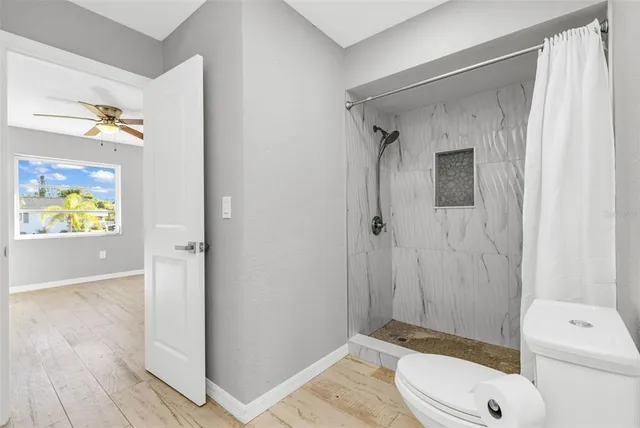 a en suite bathroom with a granite countertop sink and a mirror