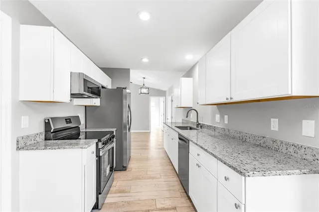 a view of kitchen with stainless steel appliances refrigerator oven and stove