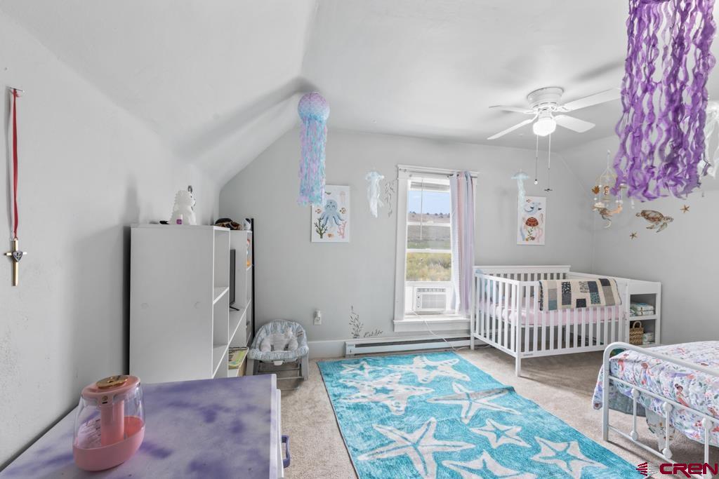 65536 Solar Road Montrose, CO 81403 - Photo 11 of 30 a bedroom with furniture and a window