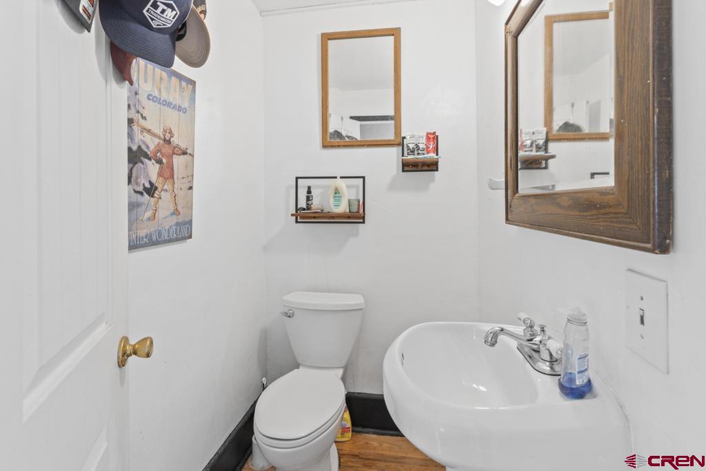 65536 Solar Road Montrose, CO 81403 - Photo 27 of 30 a bathroom with a toilet a sink and a mirror