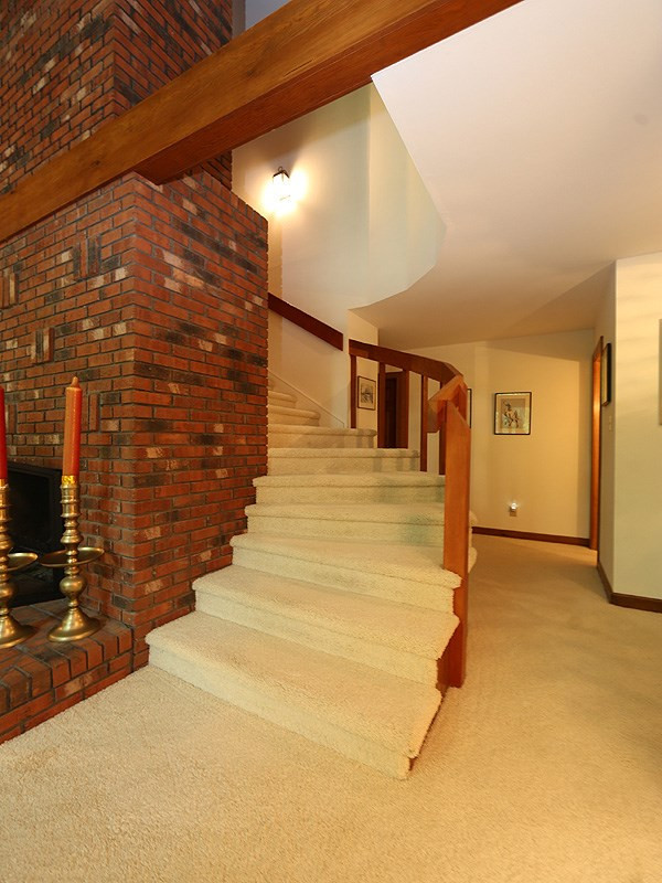8600 Valley Brook Drive Raleigh, NC 27613 - Photo 7 of 25 Staircase winds behind fireplace to upstairs master. Slate floor entrance is just to the right. Staircase