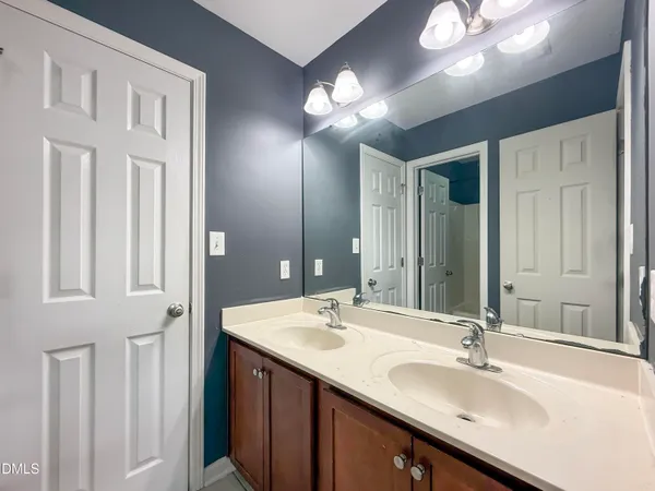 a bathroom with a sink double vanity and a mirror