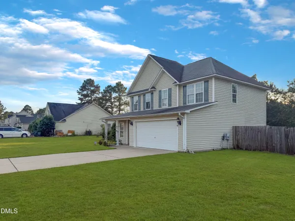 a view of a house with a backyard