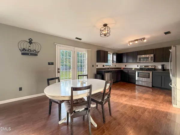 a view of a dining room with furniture window and wooden floor