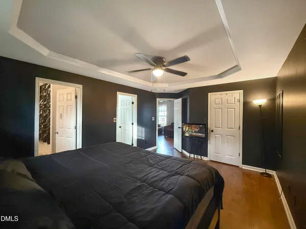 a bedroom with a large bed and a chandelier