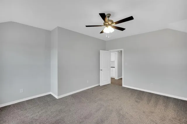 a view of an empty room with a ceiling fan