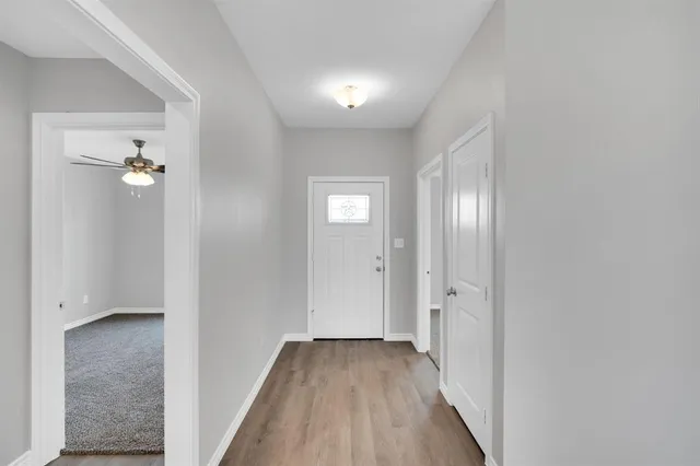 an empty room with wooden floor and closet