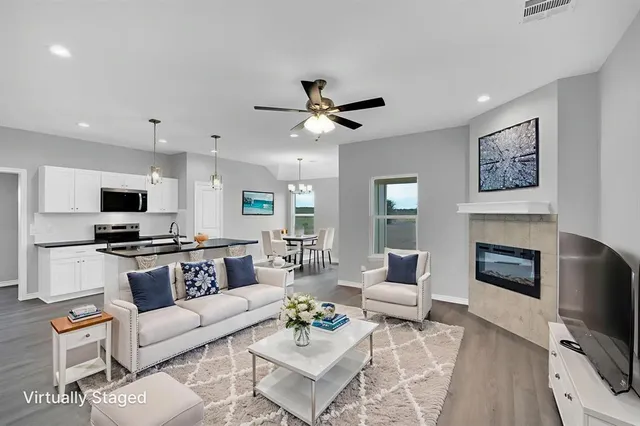 a living room with furniture a fireplace and a flat screen tv