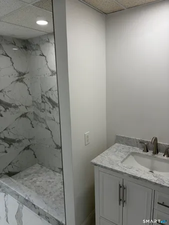 a bathroom with a granite countertop sink and a mirror