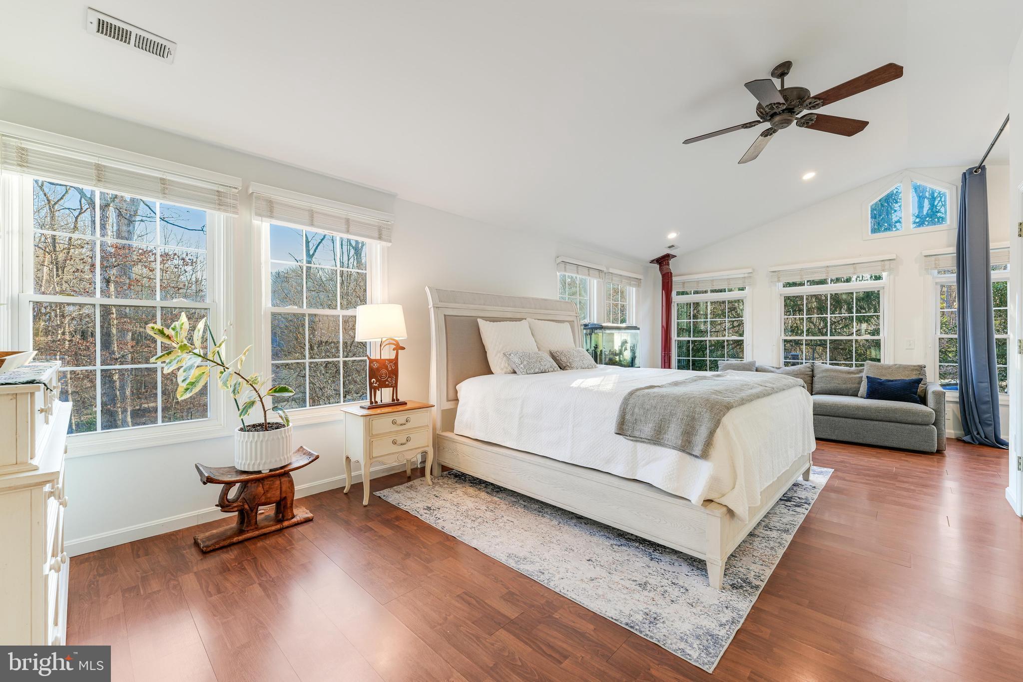 10808 Beach Mill Road Great Falls, VA 22066 - Photo 17 of 43 a spacious bedroom with a bed a table and a large window