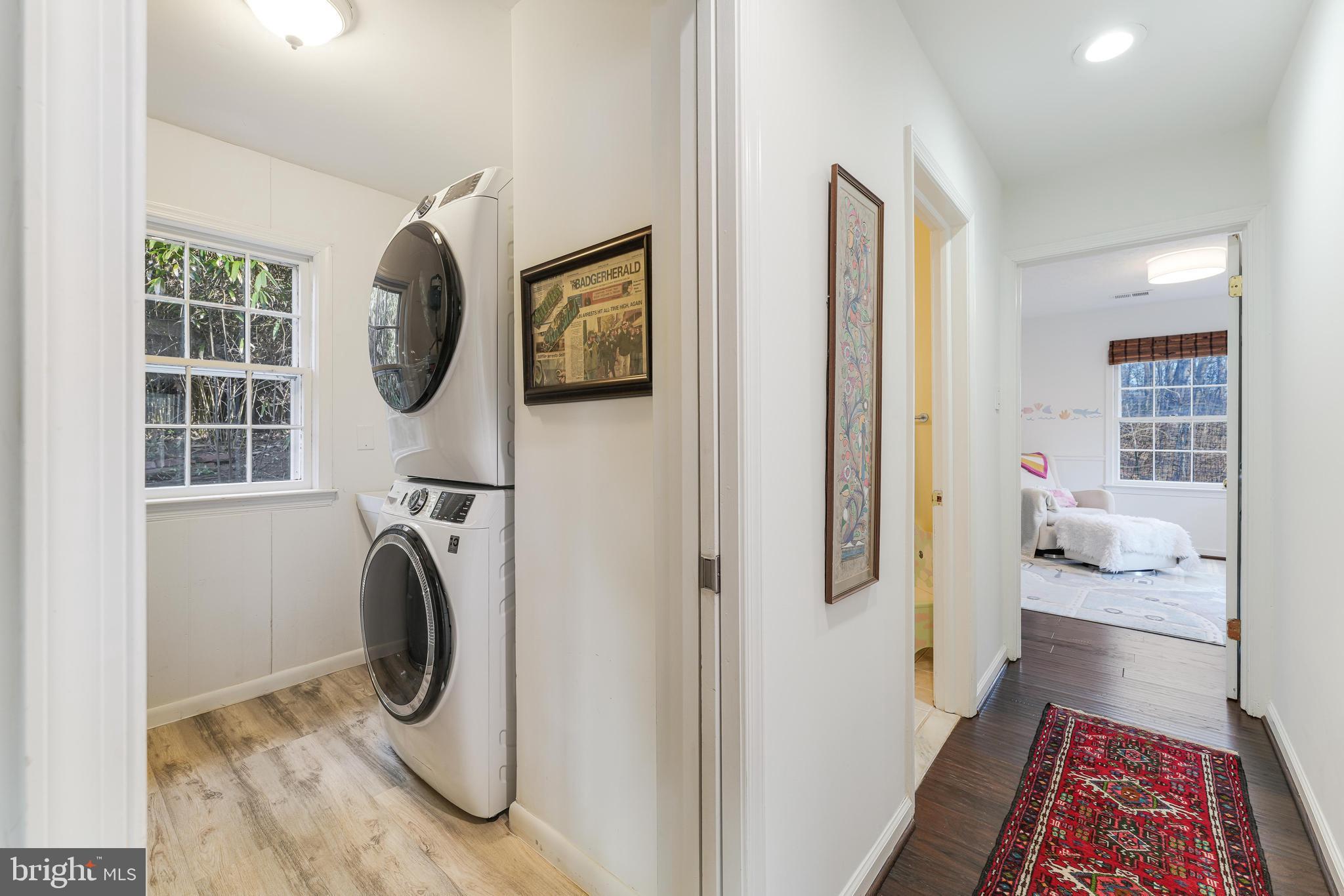 10808 Beach Mill Road Great Falls, VA 22066 - Photo 27 of 43 a view of a bedroom with washer and dryer