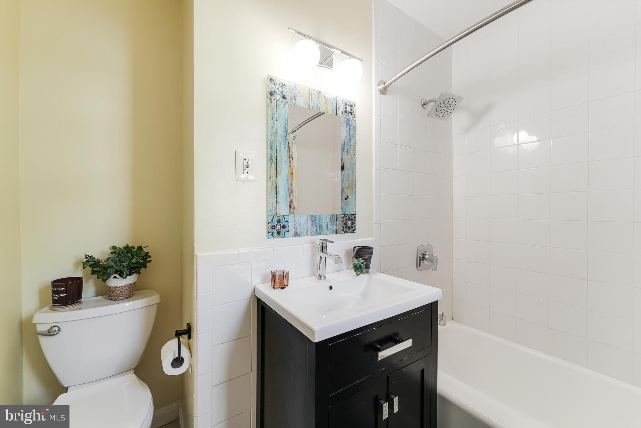 10808 Beach Mill Road Great Falls, VA 22066 - Photo 30 of 43 a bathroom with a sink toilet and shower