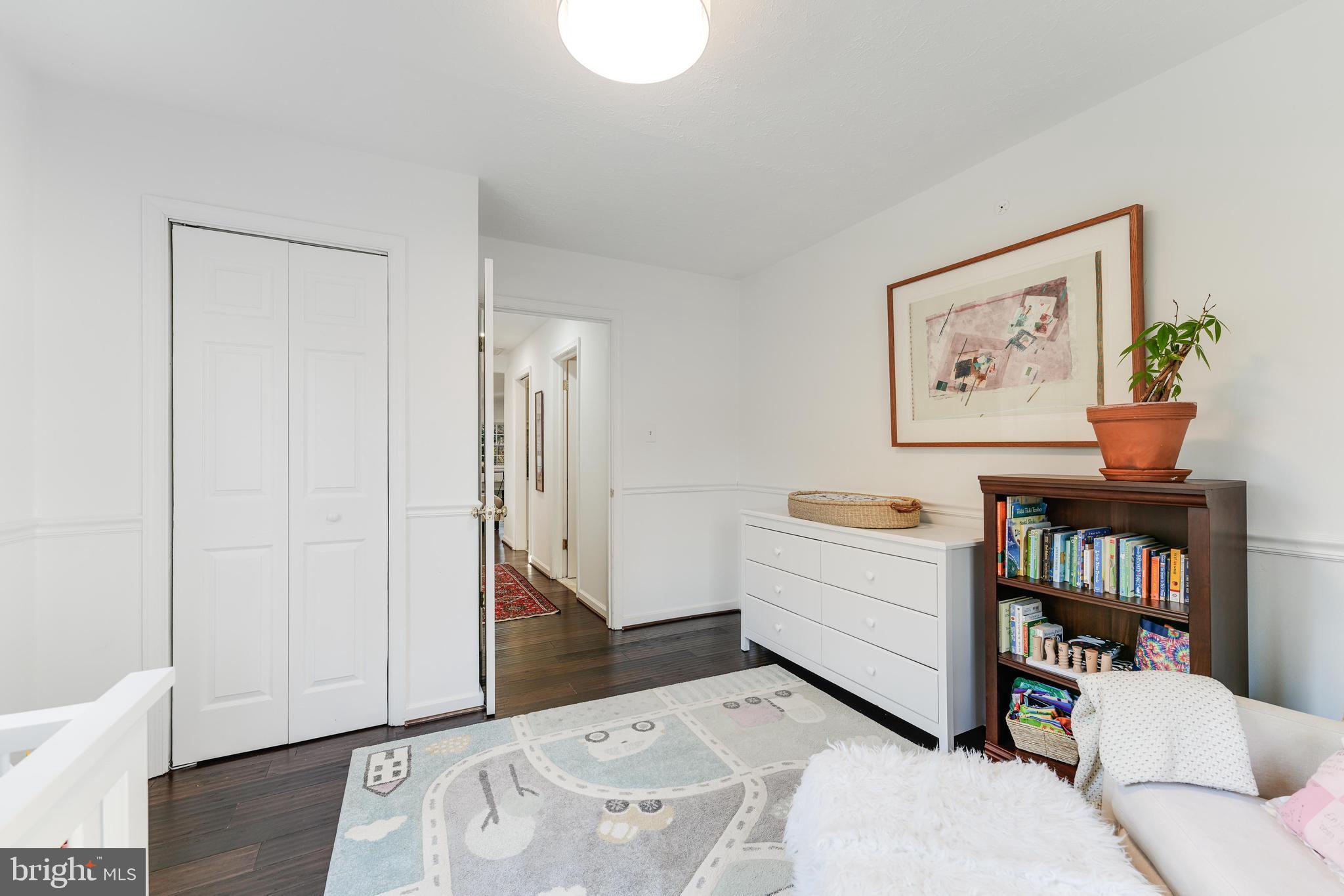 10808 Beach Mill Road Great Falls, VA 22066 - Photo 34 of 43 a bed room with a bed and a book shelf