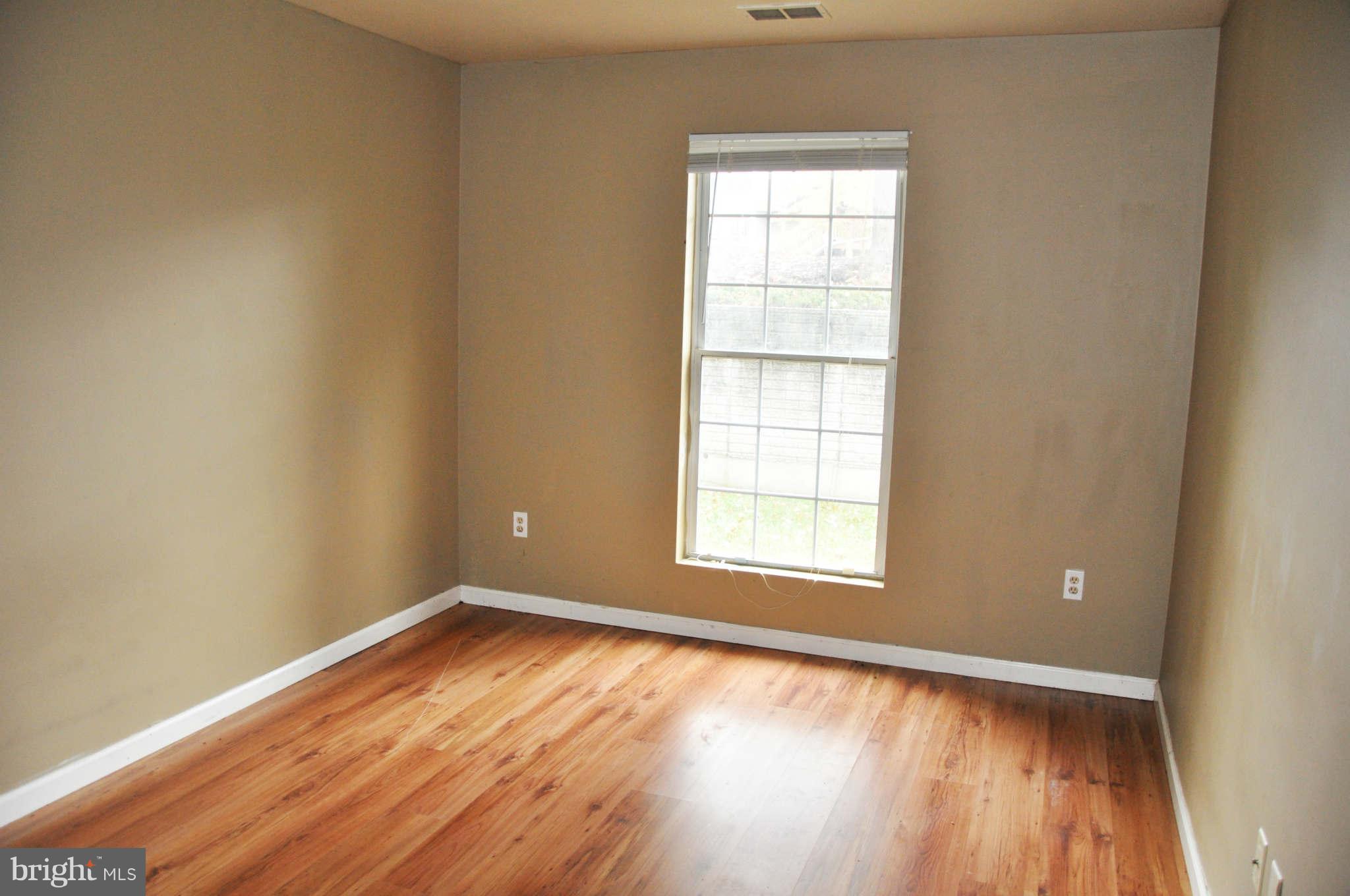 114 Timberlake Terrace, Unit 2 Stephens City, VA 22655 - Photo 13 of 22 an empty room with wooden floor and windows