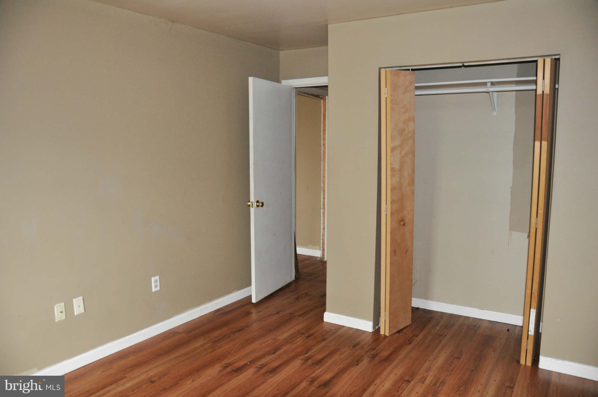 114 Timberlake Terrace, Unit 2 Stephens City, VA 22655 - Photo 14 of 22 a view of an empty room with wooden floor and a window