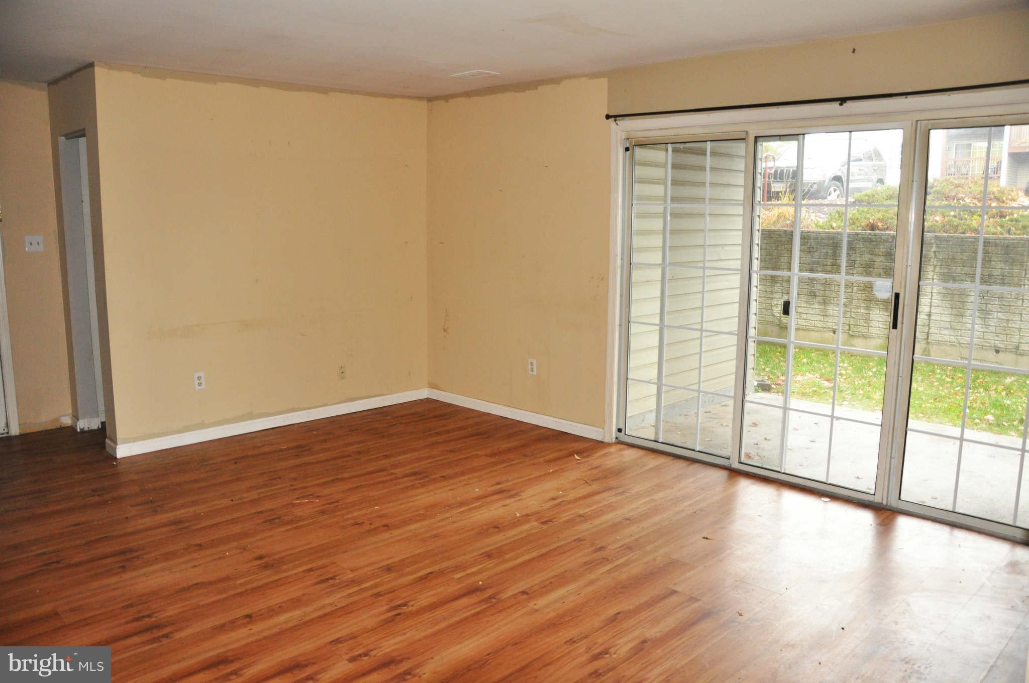 114 Timberlake Terrace, Unit 2 Stephens City, VA 22655 - Photo 3 of 22 a view of an empty room with wooden floor and a window