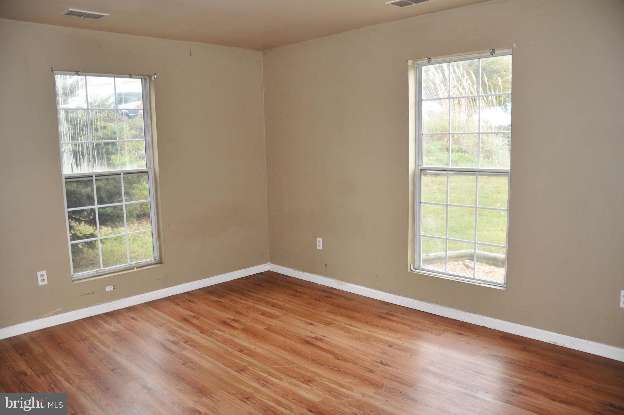 114 Timberlake Terrace, Unit 2 Stephens City, VA 22655 - Photo 10 of 22 an empty room with wooden floor and windows