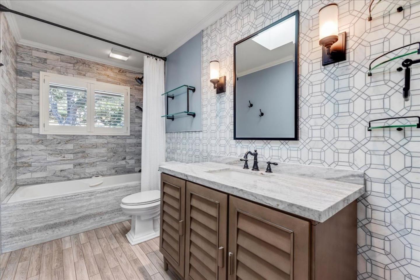 15 Mentone Road Carmel, CA 93923 - Photo 24 of 47 a bathroom with a granite countertop sink toilet and mirror