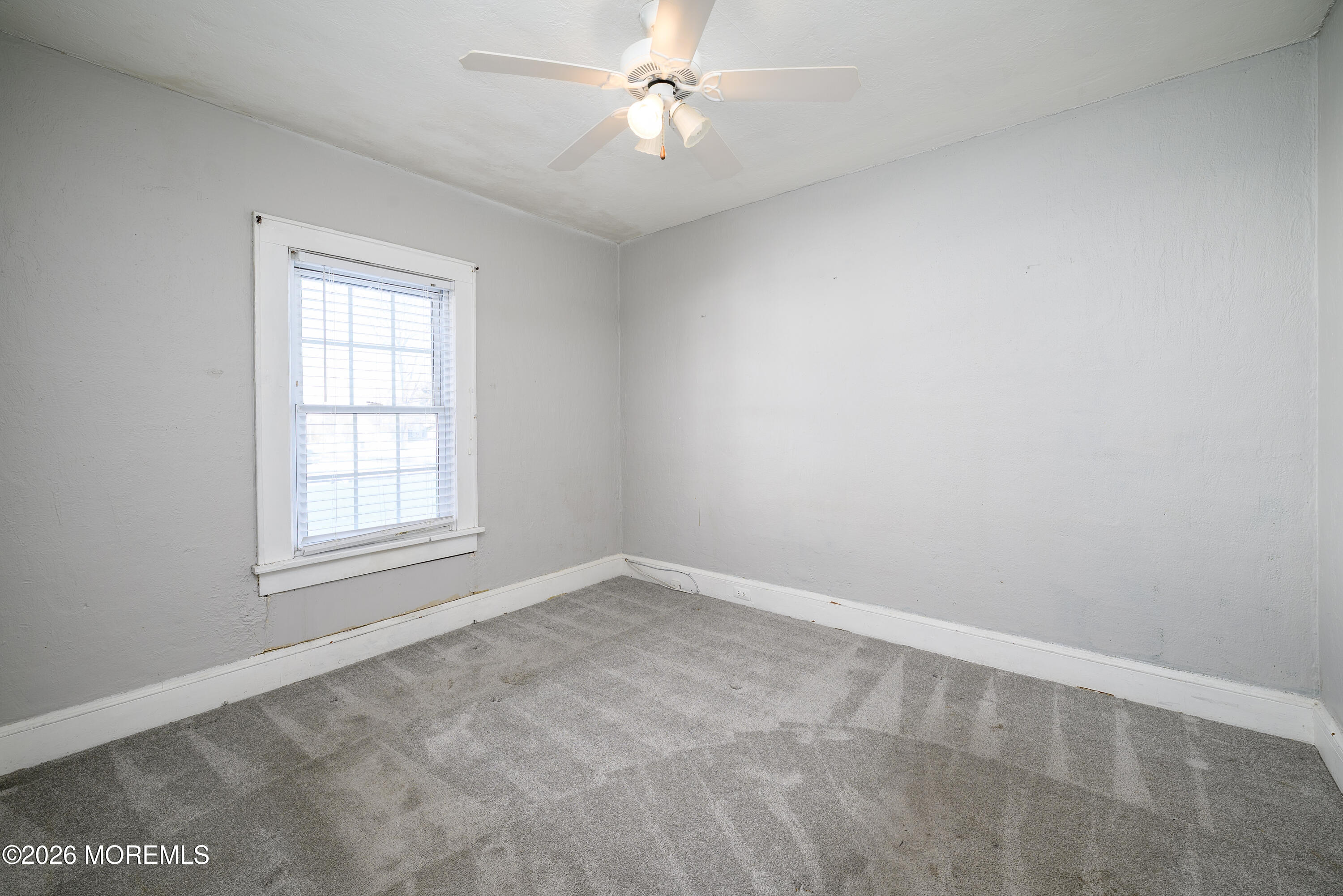 154 Lower Main Street Aberdeen, NJ 07747 - Photo 11 of 22 an empty room with a window and a ceiling fan
