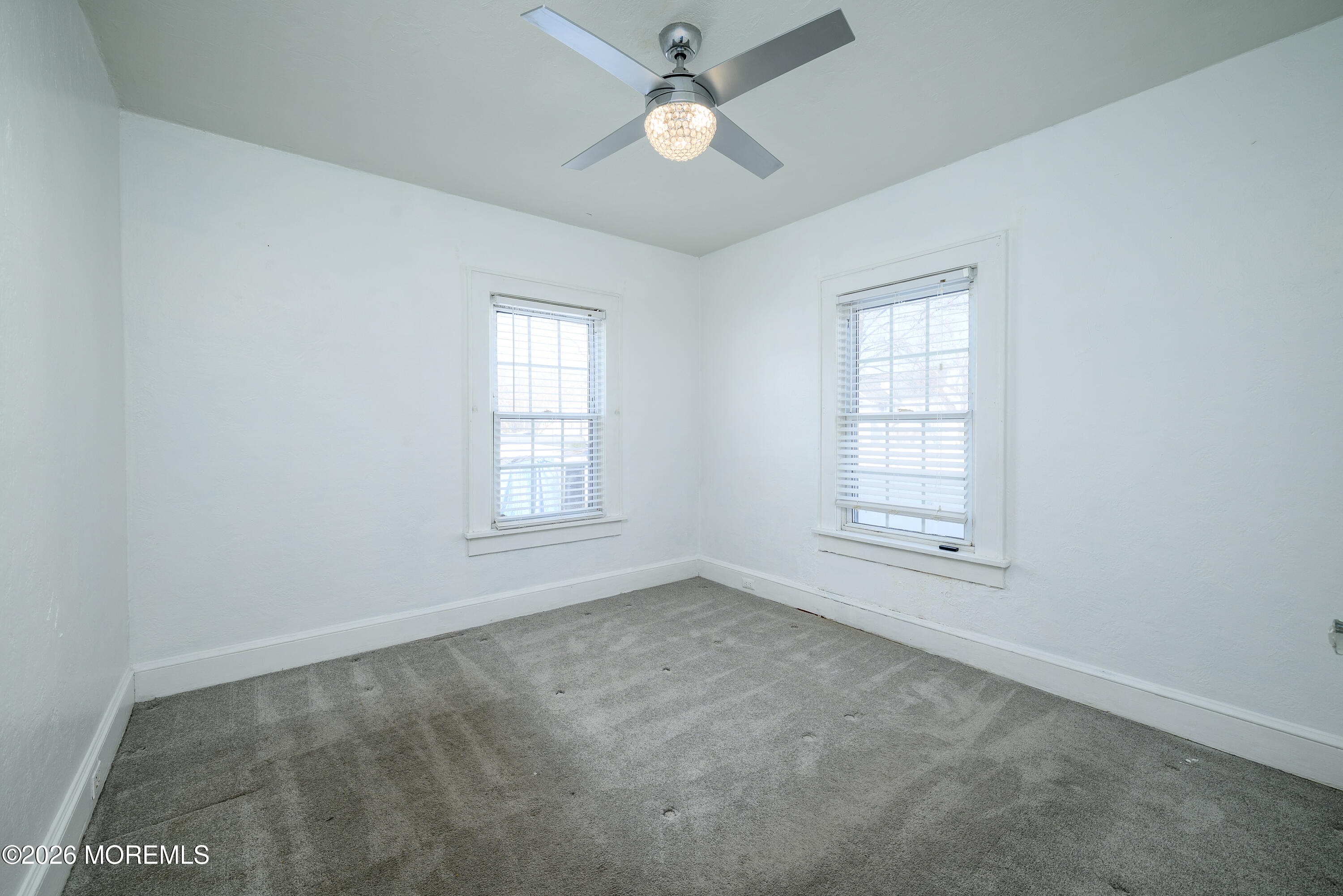154 Lower Main Street Aberdeen, NJ 07747 - Photo 13 of 22 an empty room with chandelier fan and windows