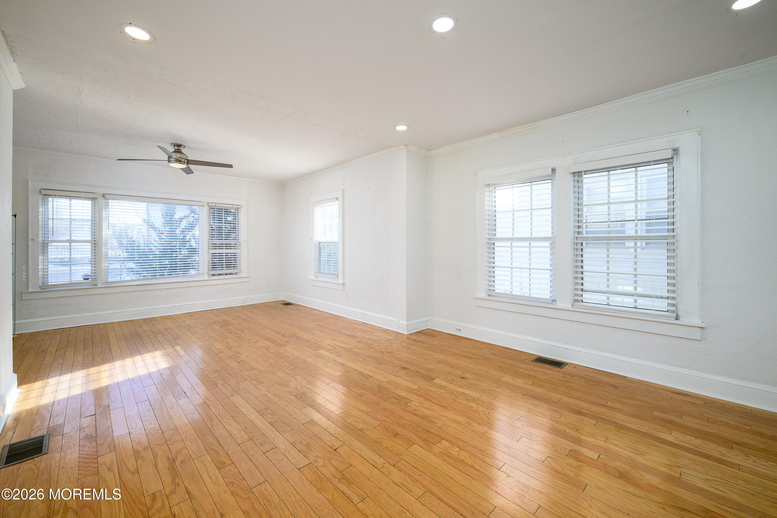 154 Lower Main Street Aberdeen, NJ 07747 - Photo 5 of 22 an empty room with wooden floor and windows