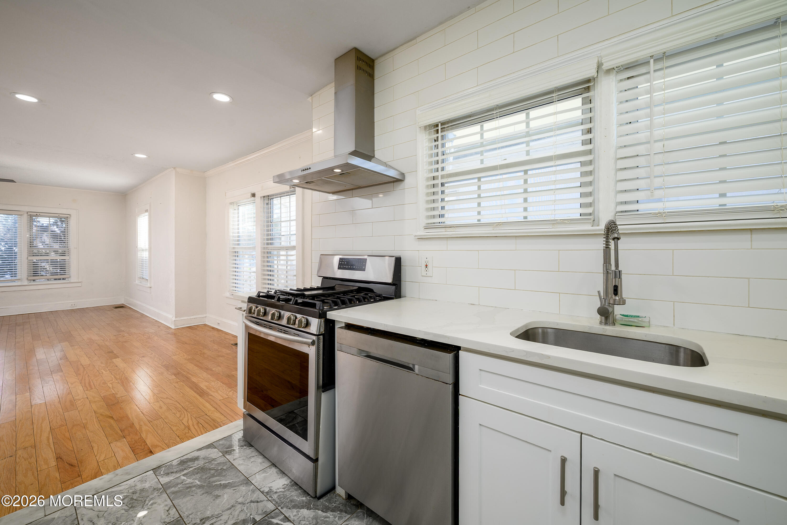154 Lower Main Street Aberdeen, NJ 07747 - Photo 7 of 22 a kitchen with stainless steel appliances granite countertop a sink and a stove