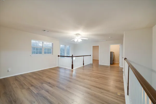 a view of a room with wooden floor and a window