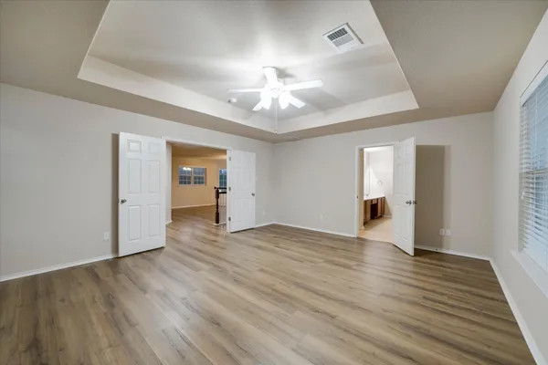a view of a room with wooden floor