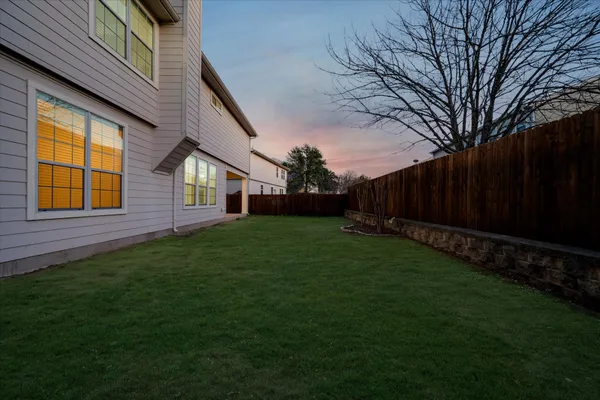 a view of a backyard with plants and a garden