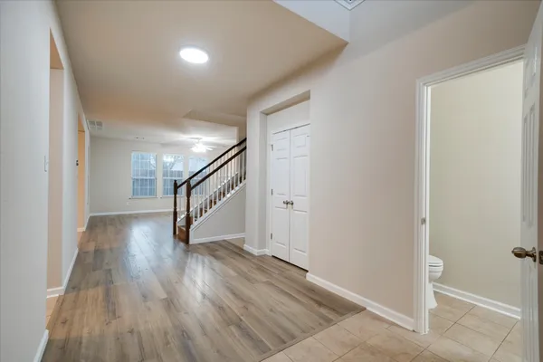a view of empty room with wooden floor and fireplace