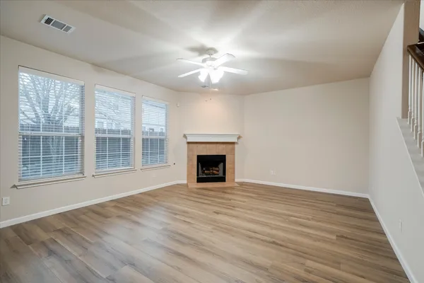 wooden floor in an empty room with a fireplace