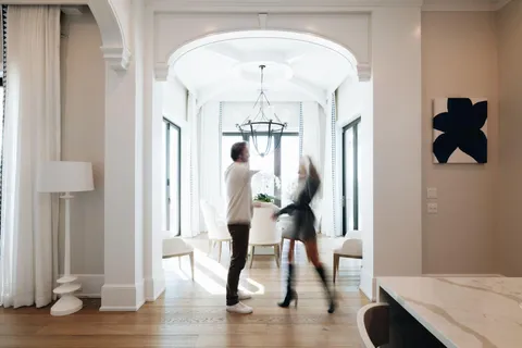 a kitchen with stainless steel appliances kitchen island granite countertop a wooden floor and white cabinets