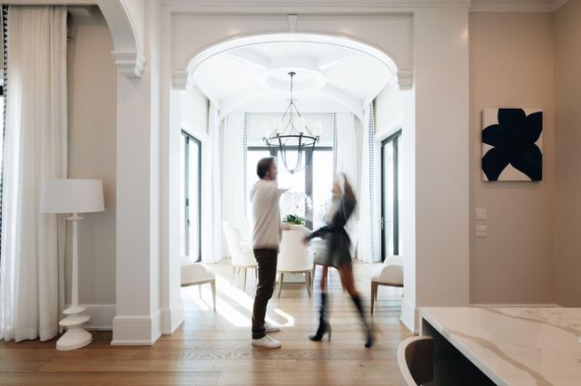 a kitchen with stainless steel appliances kitchen island granite countertop a wooden floor and white cabinets