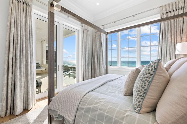 a bedroom with a bed and a mirror