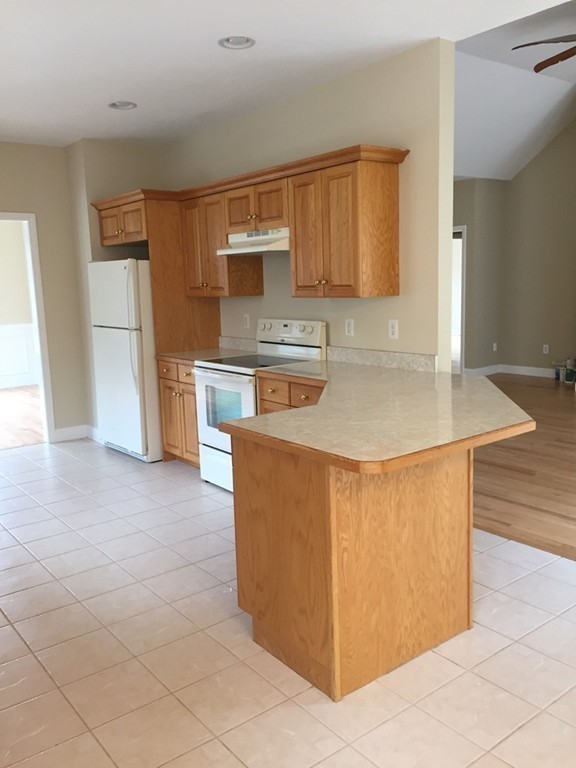 408 Nicholas Drive Lancaster, MA 01523 - Photo 11 of 30 a kitchen with stainless steel appliances granite countertop a sink a stove and a refrigerator