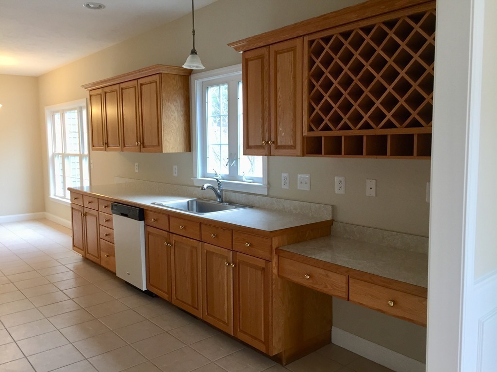 408 Nicholas Drive Lancaster, MA 01523 - Photo 12 of 30 a kitchen with a sink and cabinets