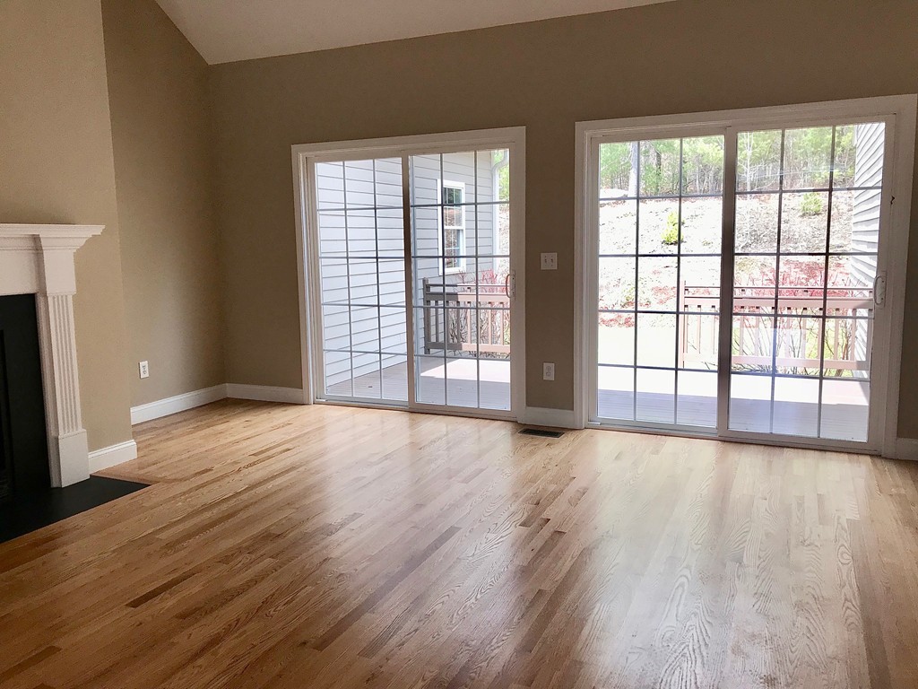 408 Nicholas Drive Lancaster, MA 01523 - Photo 13 of 30 a view of an empty room with wooden floor and a window
